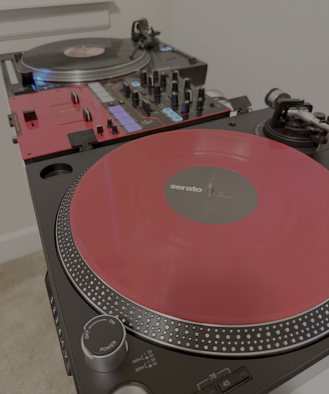 Two turntables, a mixer, and a Serato control record — a DVS setup